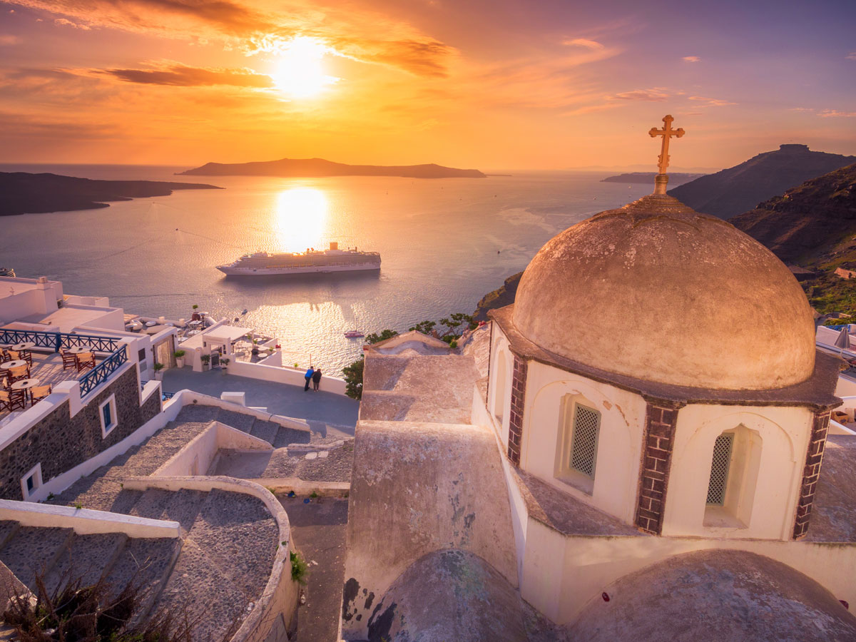 Mykonos, Greece at sunset with cruise ship in harbor